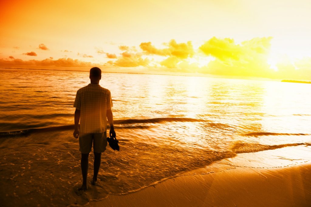 young man and sunset on Caribbean sea